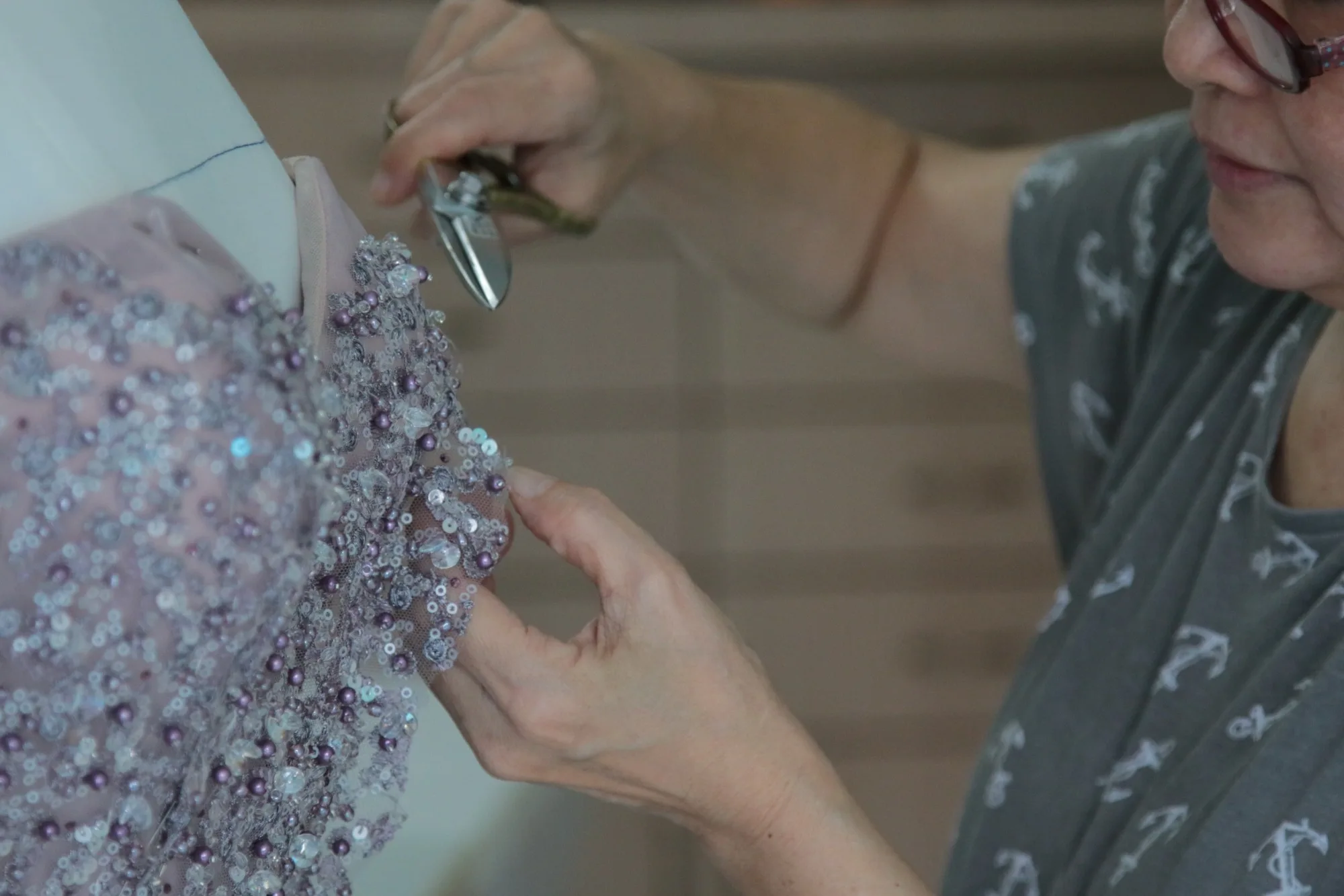 Ann Chiam (centre), a bridal gown designer, works on a bridesmaid gown with her assistant